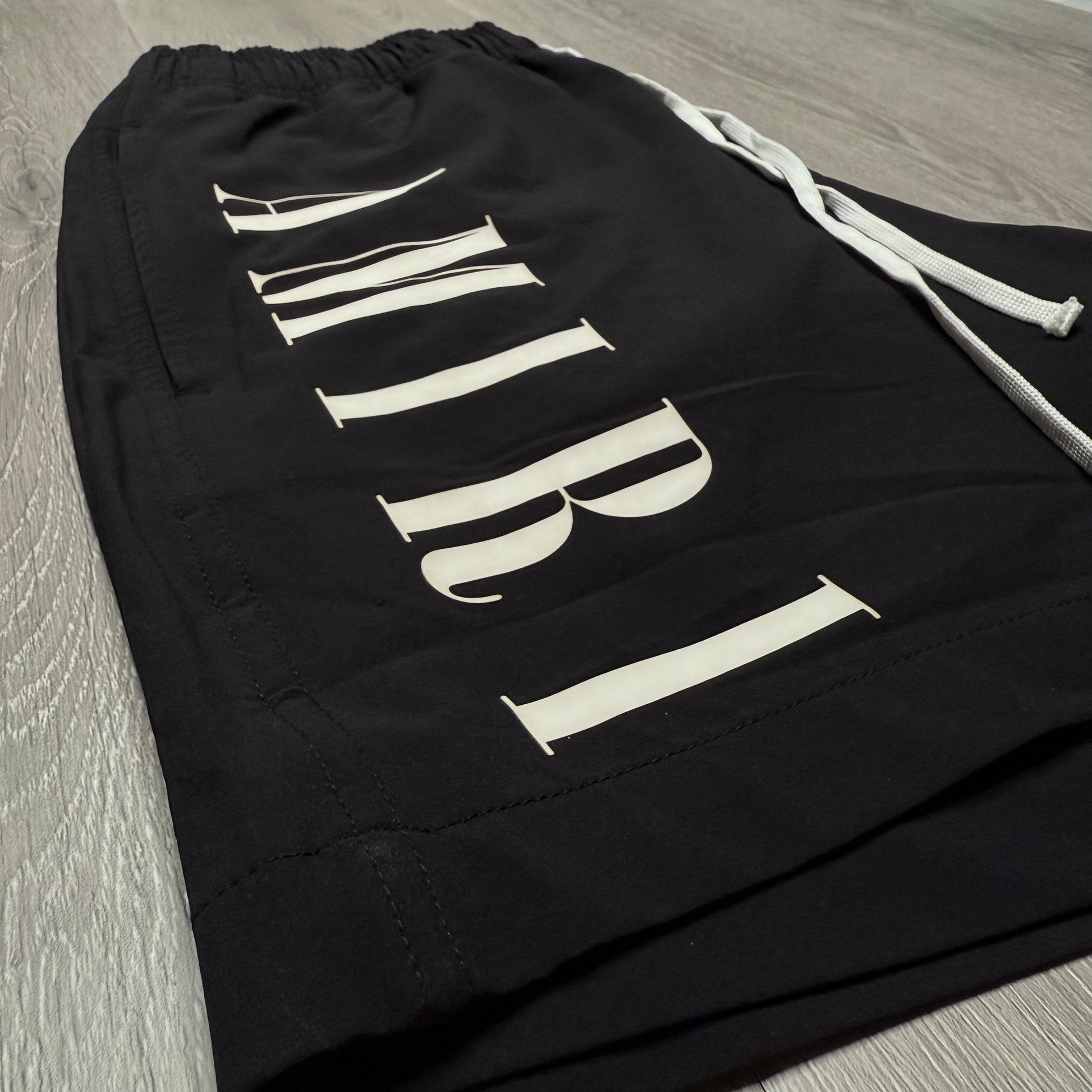 Amiri Vertical Logo Printed Swim Shorts - Black/White